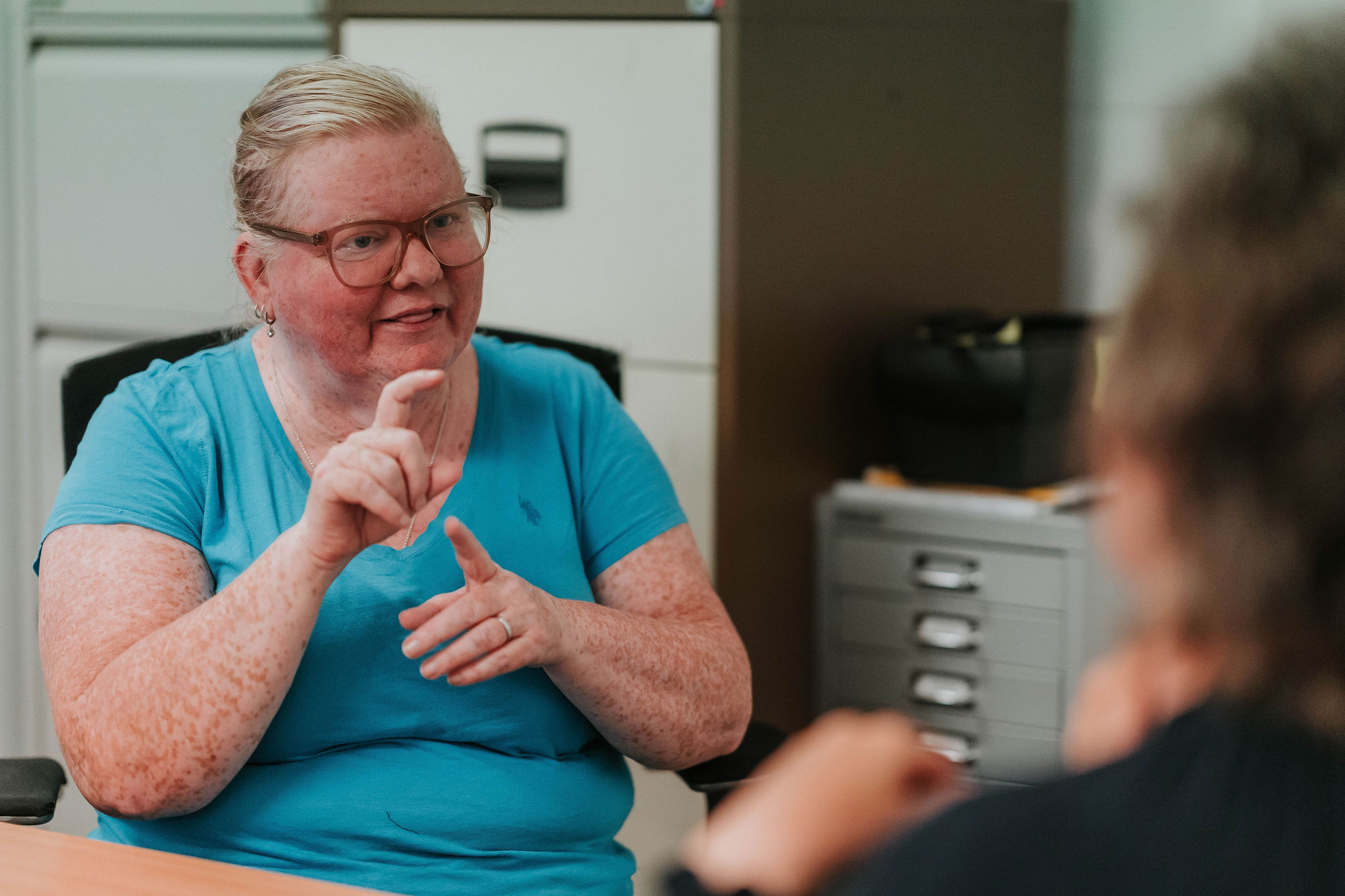 Staff member supporting a visitor at the drop-in centre